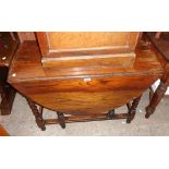 A 3' 4" 1920`s polished oak gateleg dining table, set on barley twist supports