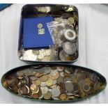 Two tins containing a quantity of mixed world and Great British coinage including US money