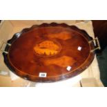 A 22 1/2" reproduction inlaid mixed wood serving tray with central shell motif, wavy gallery and