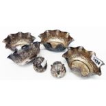 A set of four Anglo Indian white metal finger bowls with shaped rims and profuse animal and palm