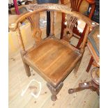 A 19th Century carved oak corner tub chair with twin pierced splats, solid seat and cabriole front