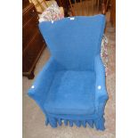 A vintage parlour armchair upholstered in blue material - sold with a matching chair with floral