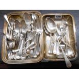 A silver plated entree dish containing assorted silver plated cutlery