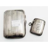 A silver cigarette case with engine turned decoration - sold with a silver vesta case - both bearing