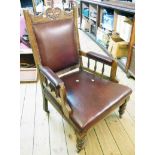 An Edwardian stained walnut framed drawing room armchair with studded oxblood leather upholstery,