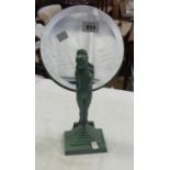 An Art Deco mirror with painted spelter figure of a nude woman on stepped base, with beveled