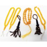 An amber style string of rosary beads, another and two beaded tassels