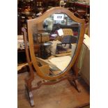 An early 20th Century mahogany and strung small shield shaped dressing table mirror