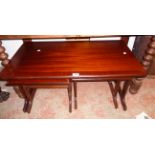 A 3' 1" reproduction mahogany and cross banded coffee table with two nesting tea tables, all set