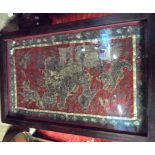 A large framed and glazed antique Oriental silk hanging, decorated with lions in metal and