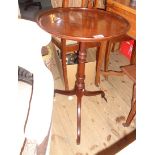 A 20th Century mahogany pedestal wine table, set on turned pillar and tripod base