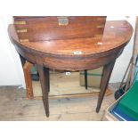 A 36" 19th Century mahogany, cross banded and strung fold-over tea table, set on square tapered legs