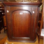 A 24" 19th Century quarter sawn oak wall hanging corner cabinet with fluted sides and panelled door