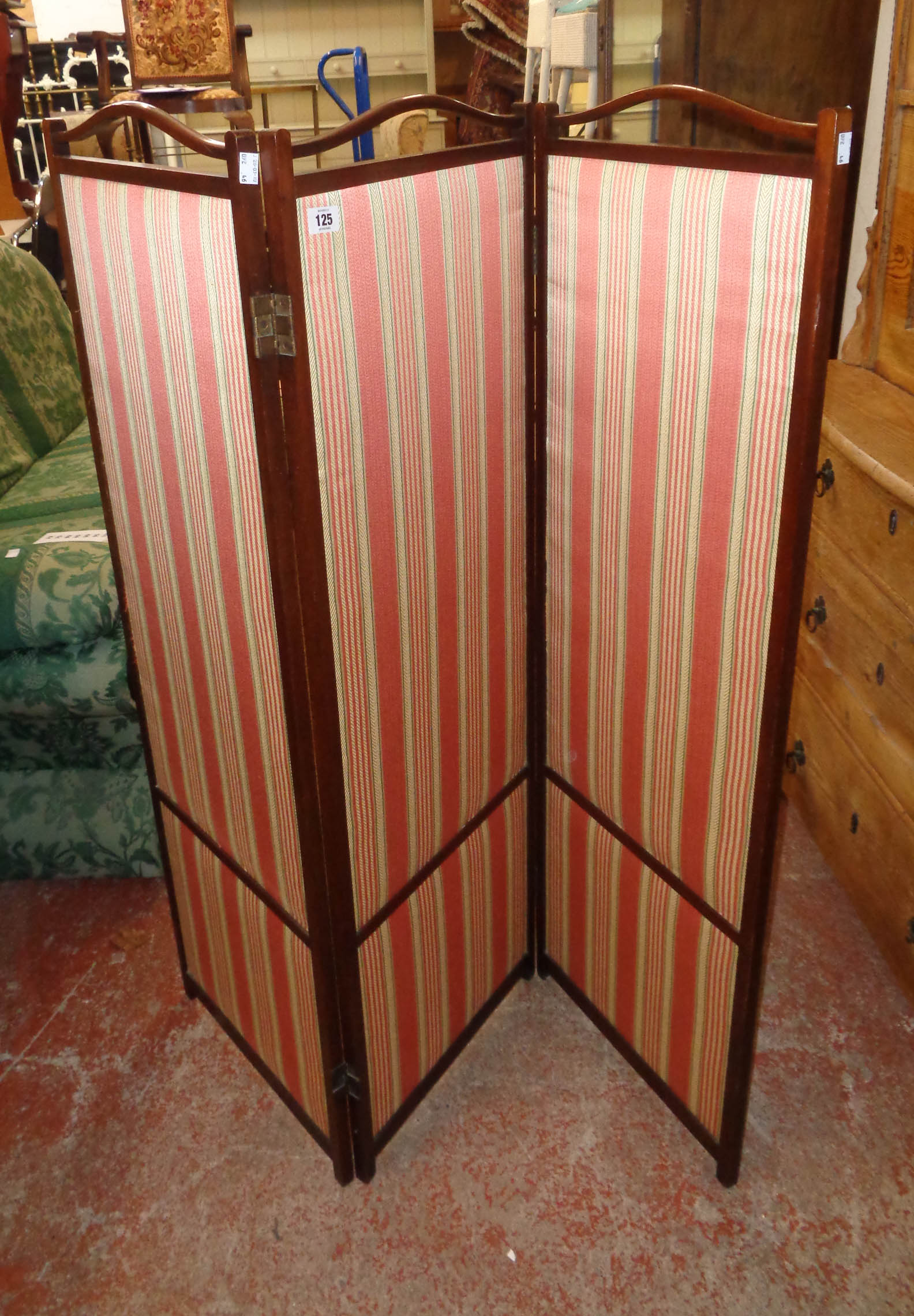 An early 20th Century mahogany framed three fold dressing screen with upholstered panels