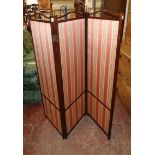 An early 20th Century mahogany framed three fold dressing screen with upholstered panels