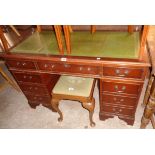 A 4' reproduction mahogany twin pedestal desk with green leather inset top, three frieze drawers and