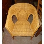 A cane and wicker tub shaped chair