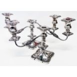 A pair of silver twin branch candelabra with detachable nozzles, ornate cast and embossed