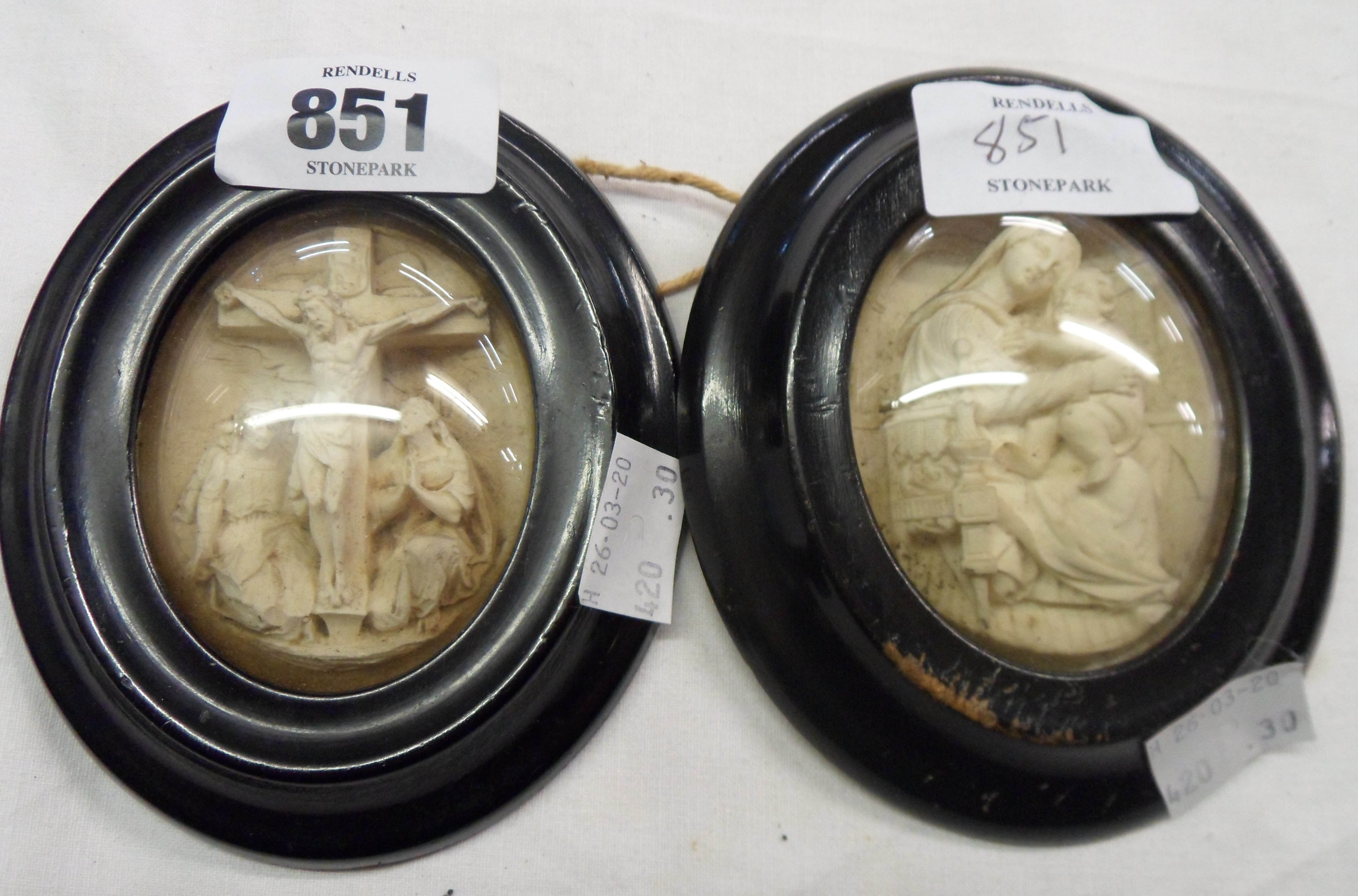 A pair of oval framed relief plaster religious miniatures