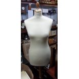 A mannequin torso on stand