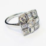 A marked PLAT Art Deco style panel ring, set with central diamond within an alternating baguette and