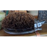 A cast iron and brush bristle hedgehog pattern boot scraper