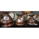 A set of three graduated Victorian copper jugs, half gill to half pint