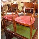 A pair of reproduction mahogany framed elbow chairs with swept armrests and corduroy upholstered