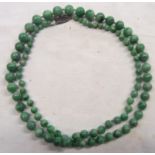 A vintage apple jade graduated bead necklace with marked silver clasp