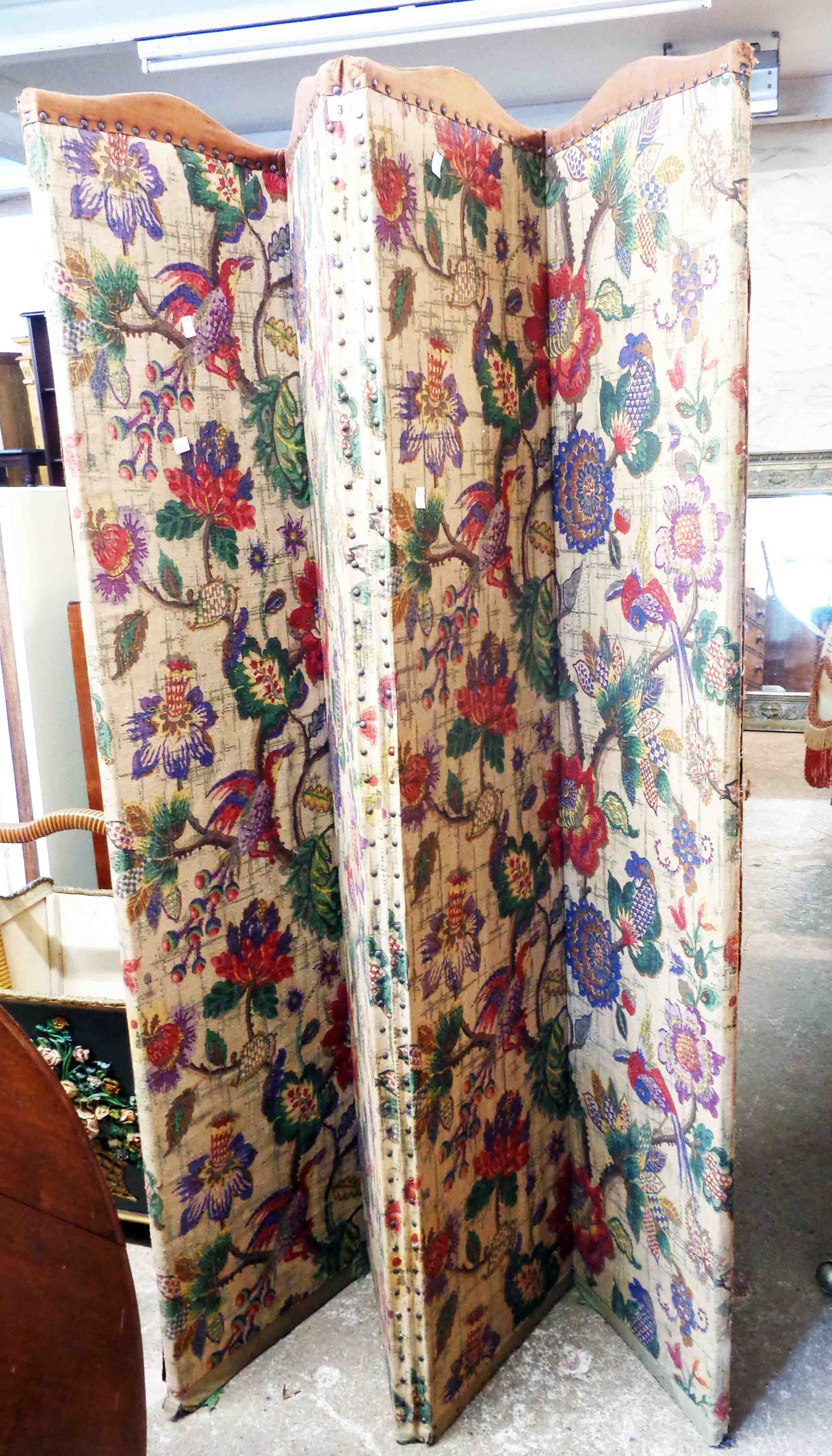 A vintage four fold dressing screen with floral panel upholstery