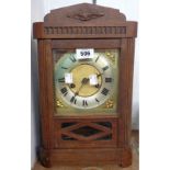 An early 20th Century oak cased shelf clock with brass and silvered dial, visible pendulum and eight