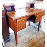 A 3' 3" Edwardian inlaid mahogany knee-hole desk with brass gallery and flanking shelves to top over