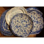 A box containing nine assorted blue and white plates and meat plates