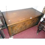 A 3' 3" 20th Century polished oak blanket chest with carved decoration to front