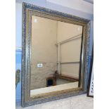 An ornate gilt framed oblong wall mirror