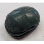 A large green Egyptian tourist ware scarab with heiroglyphs to base