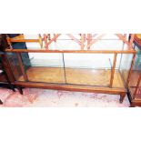 A 6' vintage oak and glazed shop display cabinet with metal shelf supports, pair of sliding doors