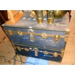 A pair of vintage brassed metal bound travelling trunks with blue canvas weather coating