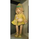 A large vintage cloth doll in the Norah Wellings style with pixie hat and fur collared coat - some