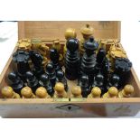 A box containing a turned wood set of St George chess men