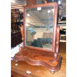 A Victorian mahogany platform dressing table mirror with serpentine base, set on squat bun feet