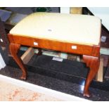 An early 20th Century stained walnut framed dressing stool with upholstered drop-in seat panel,