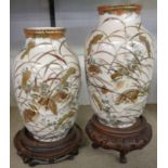 A pair of Japanese Kutani vases decorated with nesting birds, and two associated stands