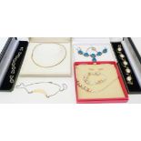 Six boxed costume jewellery items including silver gilt necklace, other necklaces and bracelets