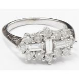 A hallmarked 750/18kt white gold Art Deco style ring, set with three central baguette diamonds