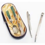 An Oriental marked sterling silver butter knife and sugar spoon with jadeite handles - sold with a