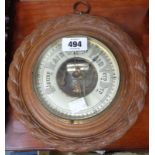 An early 20th Century Paragon oak framed sedan style wall barometer with rope twist border and