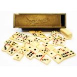 A small silver plated box containing a set of bone miniature dominoes