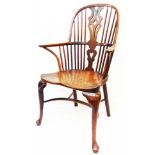 An 18th Century yew and elm Windsor elbow chair with pierced splat and stick back, wide moulded
