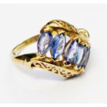 A hallmarked 375 gold ring, set with five marquise cut pale tanzanite stones and decorative